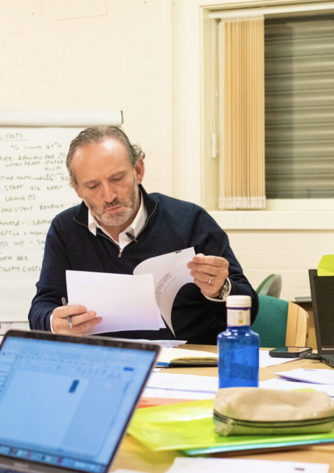Board member reviewing notes at a meeting in The Bronte Youth and Community Centre