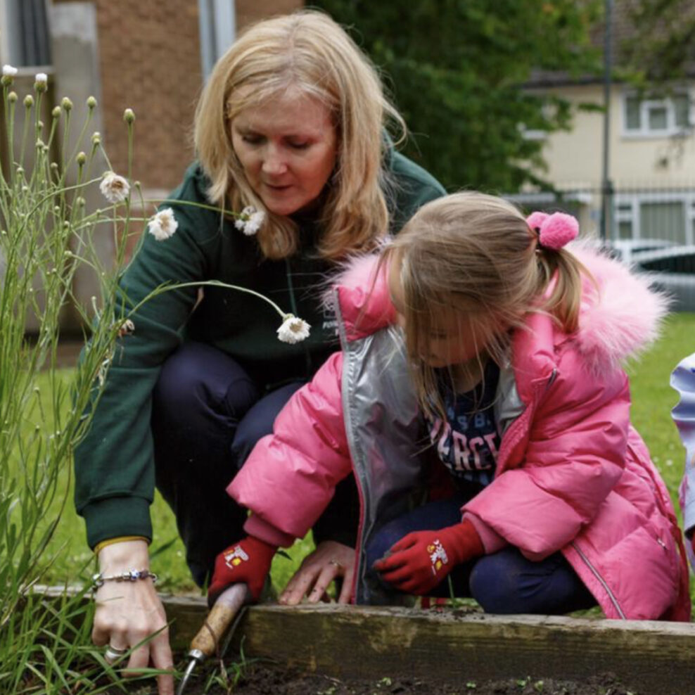 A young person learning how to garden with a volunteer in the garden at The Bronte Youth and Community Centre based in Liverpool City Centre
