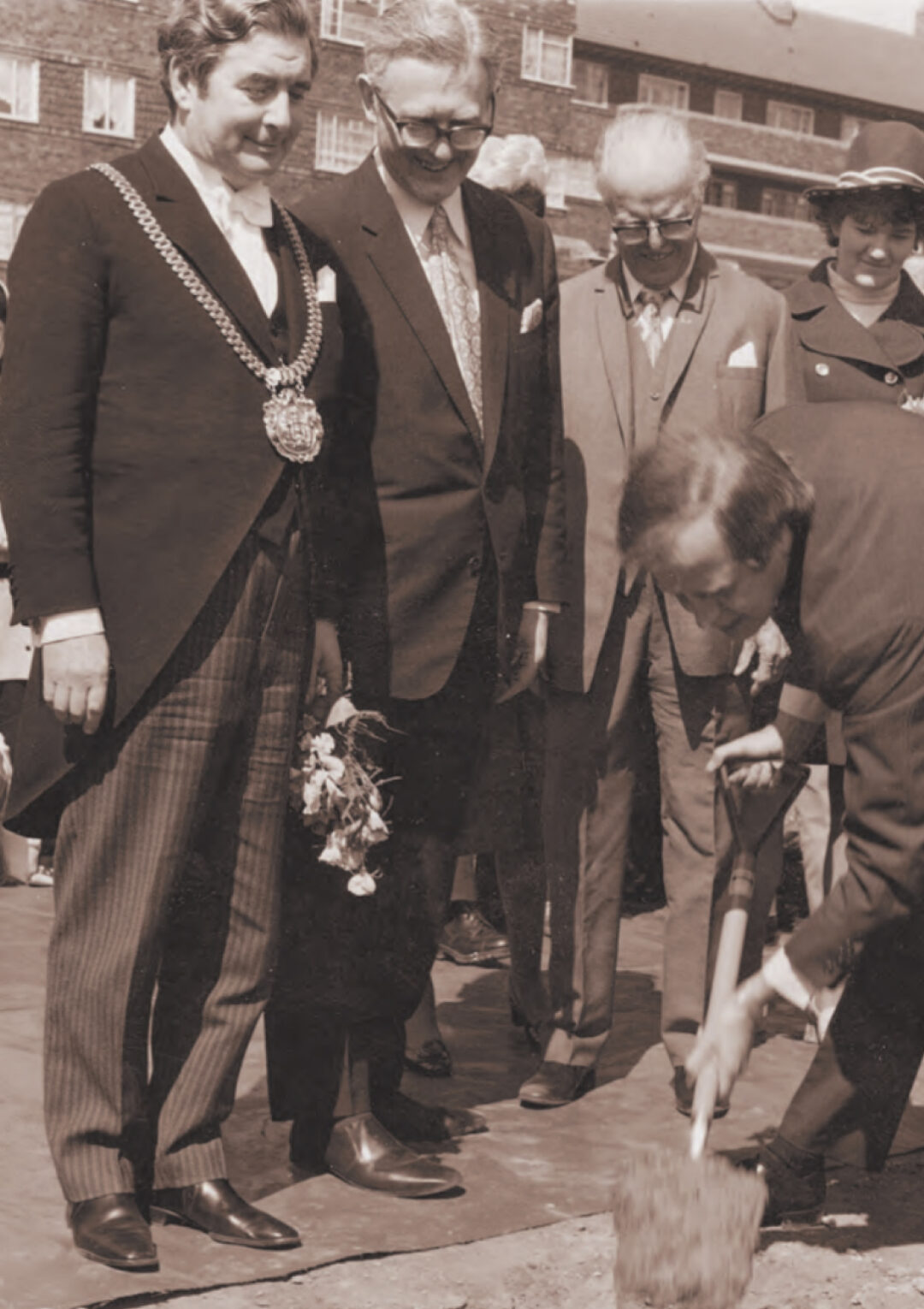 John Moores and group breaking ground on The Bronte Youth and Community Centre building in the 1970's with the Bullring in the background based in Liverpool City Centre