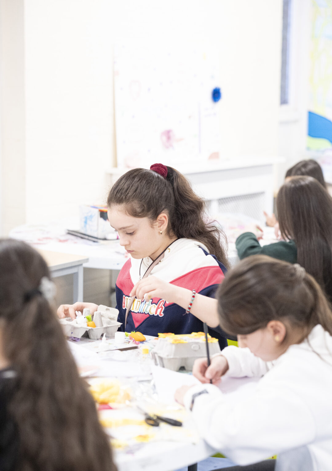 A group of young people doing crafts and painting together as part of our youth club activities at The Bronte Youth and Community Centre based in Liverpool City Centre