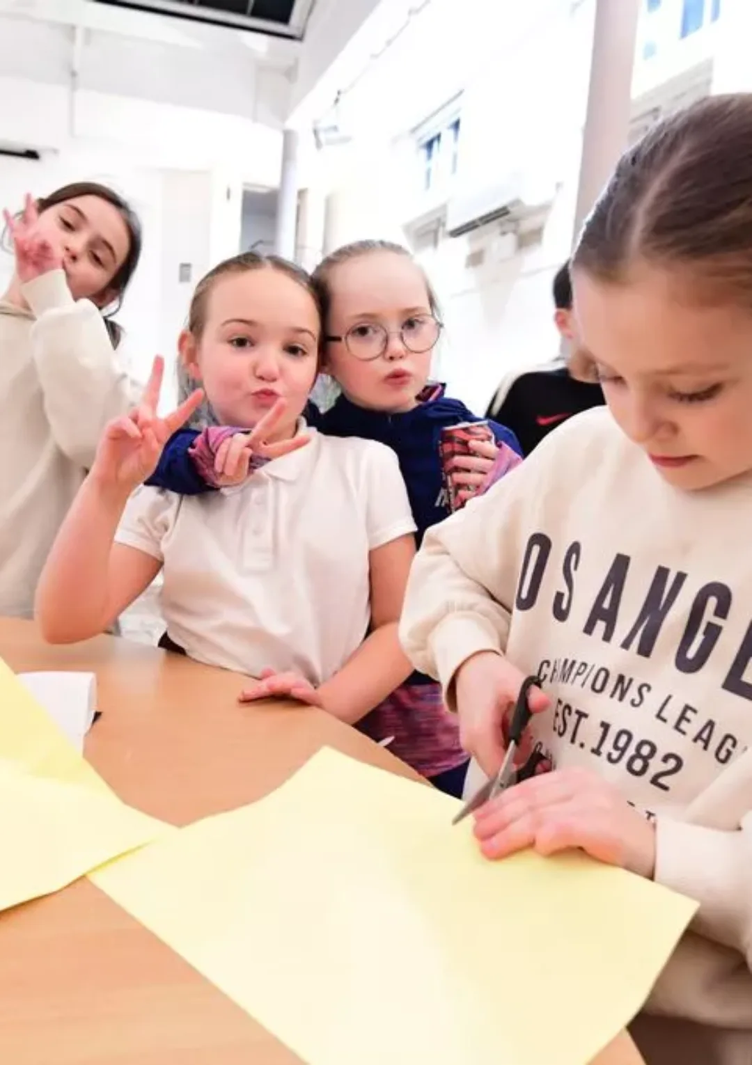 A group of young people posing and crafting for a picture together taken by the Liverpool Echo as part of a feature on the Bronte Youth and Community Centre that was released in 2025