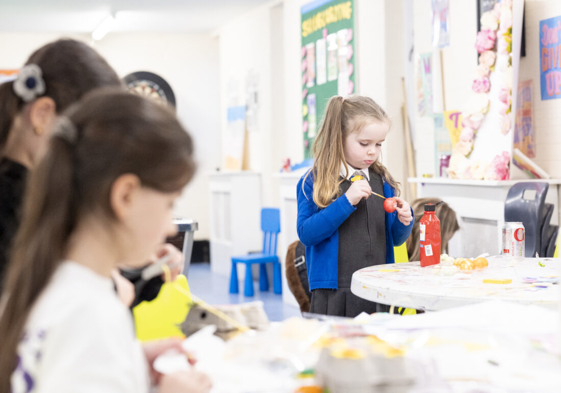 A young person at The Bronte Youth and Community Centre painting and decorating crafts, enjoying a creative and hands-on arts activity