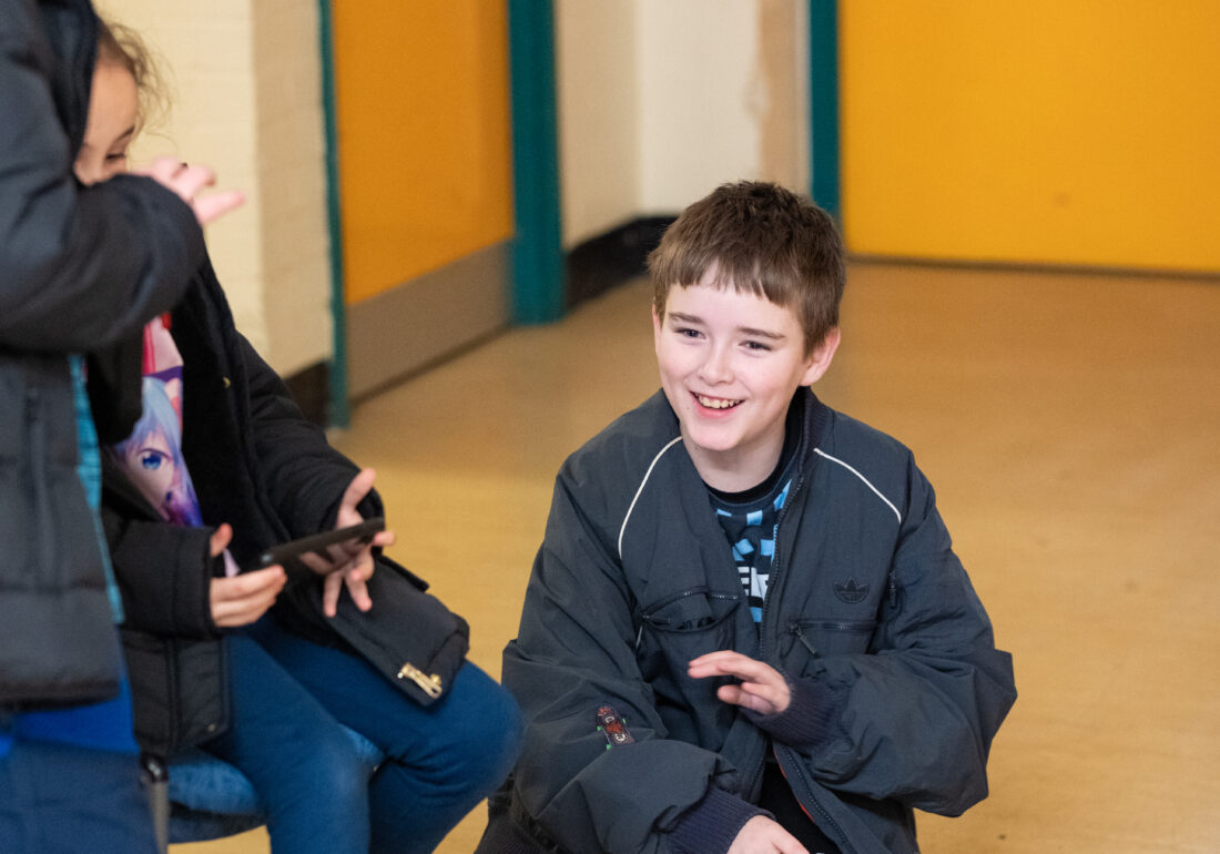Three young people enjoying a gaming session on a console at the Bronte Youth and Community Centre, fostering social connection and fun